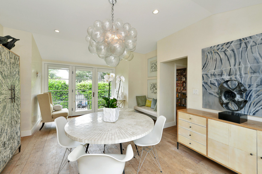 Inspiration for a contemporary separate dining room in San Francisco with light hardwood floors and white walls.