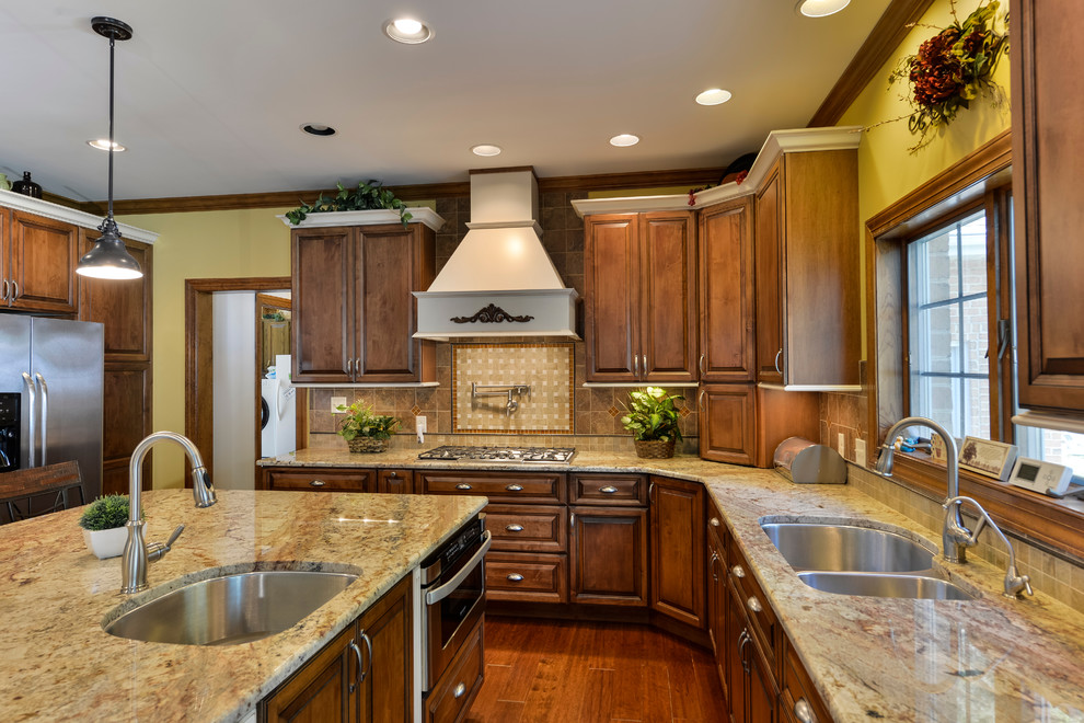 Eat-in kitchen - large transitional u-shaped medium tone wood floor eat-in kitchen idea with beaded inset cabinets, medium tone wood cabinets, granite countertops, beige backsplash, mosaic tile backsplash, stainless steel appliances and an island