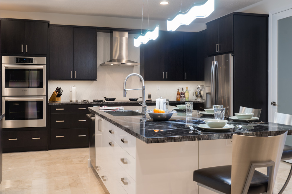 Inspiration for a large transitional l-shaped eat-in kitchen in Miami with an undermount sink, shaker cabinets, black cabinets, granite benchtops, grey splashback, glass tile splashback, stainless steel appliances, marble floors, with island, beige floor and black benchtop.