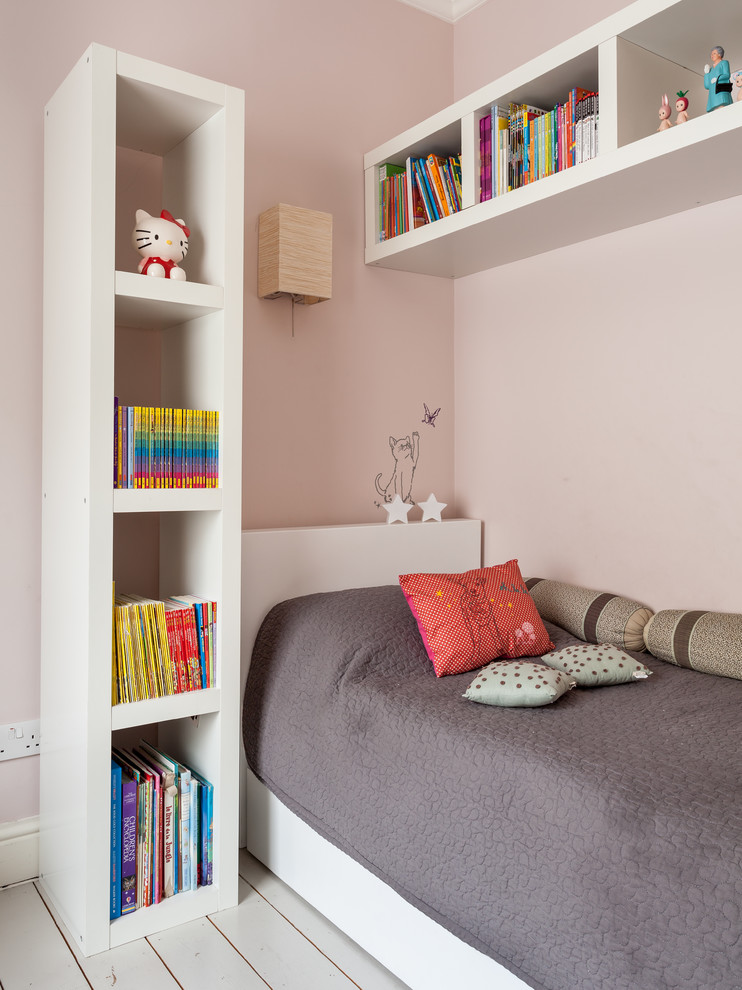 Inspiration for a contemporary kids' room for girls in London with pink walls and painted wood floors.