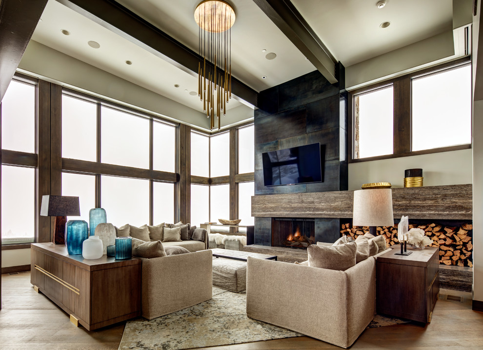 This is an example of a large contemporary open concept family room in Salt Lake City with beige walls, dark hardwood floors, a standard fireplace, a concrete fireplace surround, a wall-mounted tv and brown floor.
