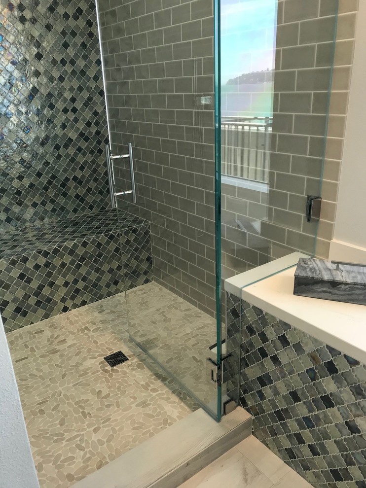 Transitional bathroom in San Francisco with an alcove shower, multi-coloured tile, glass tile, white walls and a hinged shower door.