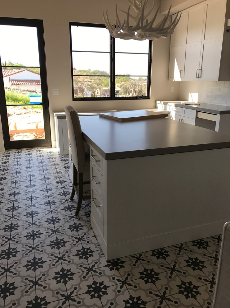 Photo of a mid-sized modern craft room in Sacramento with white walls, tatami floors, no fireplace, a freestanding desk and multi-coloured floor.