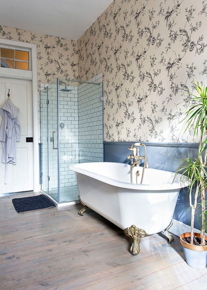 Inspiration for a large transitional kids bathroom in Edinburgh with a corner shower, multi-coloured walls, medium hardwood floors, brown floor, a hinged shower door and a claw-foot tub.