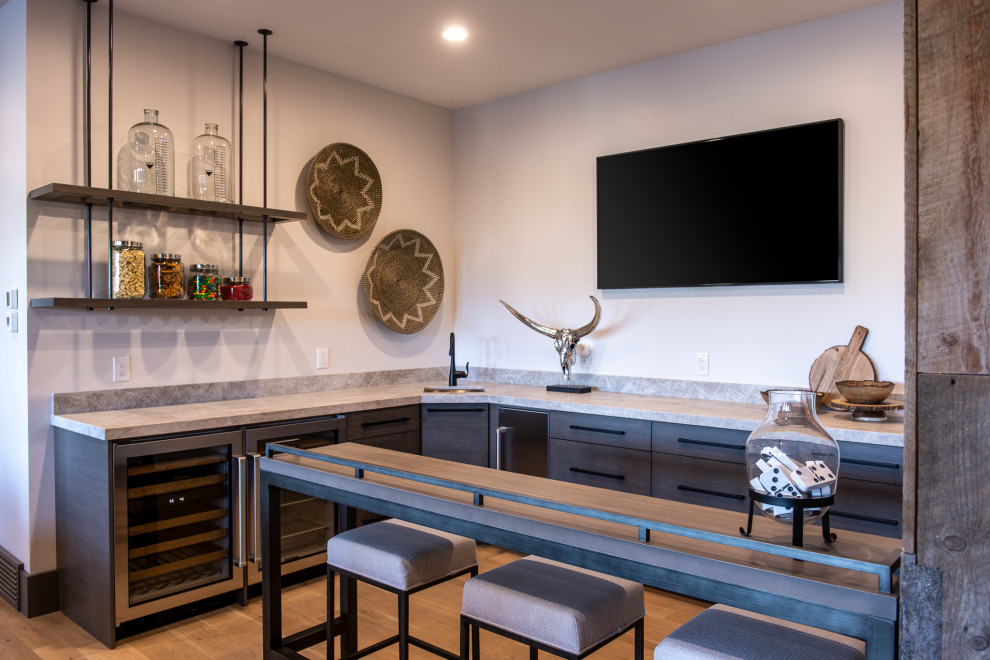 Seated home bar - mid-sized contemporary l-shaped medium tone wood floor and beige floor seated home bar idea in Salt Lake City with an undermount sink, flat-panel cabinets, medium tone wood cabinets, gray backsplash and gray countertops