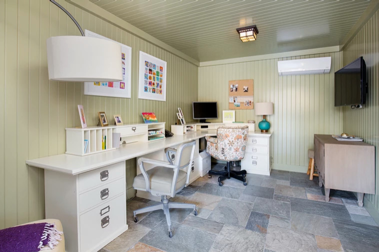 Large arts and crafts craft room in Los Angeles with green walls, slate floors, a built-in desk, multi-coloured floor, wood and panelled walls.