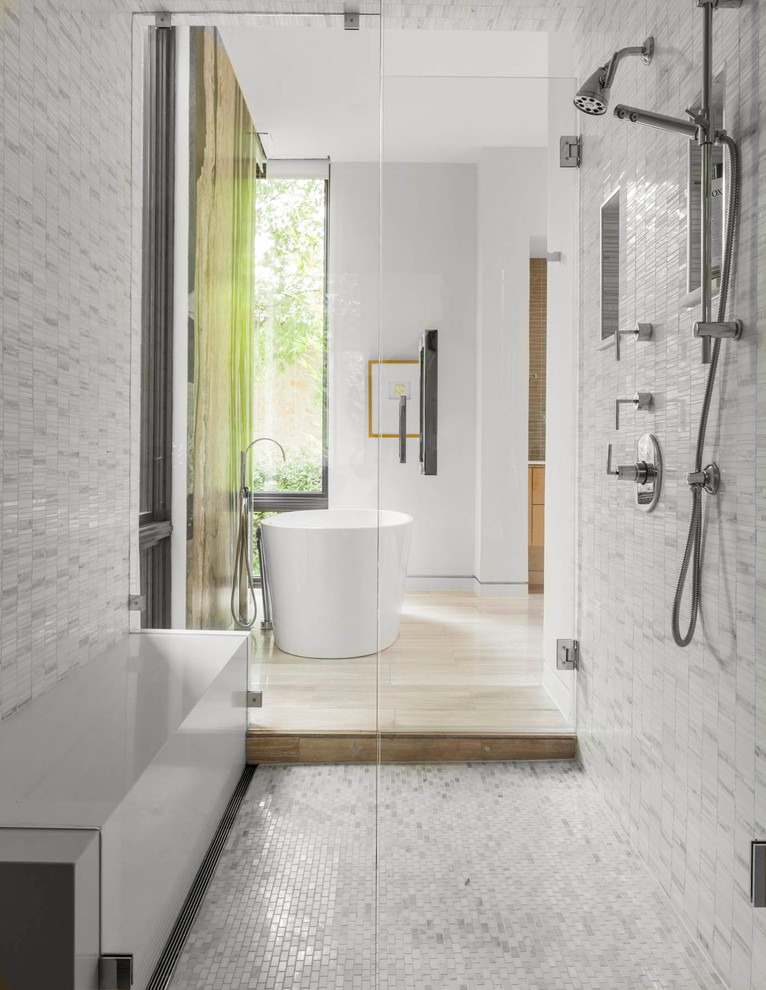 This is an example of a mid-sized contemporary master bathroom in Dallas with a freestanding tub, an alcove shower, gray tile, white tile and a hinged shower door.