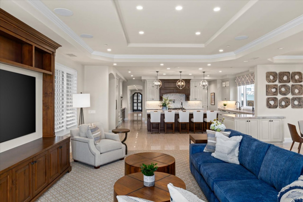 Large beach style open concept carpeted, beige floor and tray ceiling family room photo in San Diego with white walls