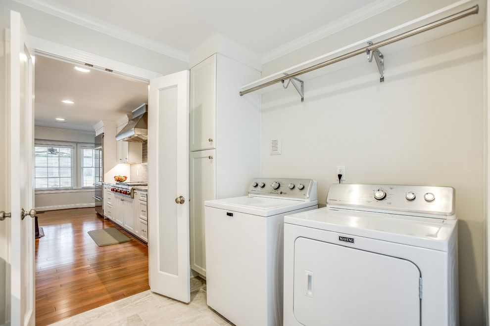 This is an example of a mid-sized transitional galley dedicated laundry room in Birmingham with recessed-panel cabinets, white cabinets, marble benchtops, grey walls, porcelain floors, a side-by-side washer and dryer, grey floor and multi-coloured benchtop.