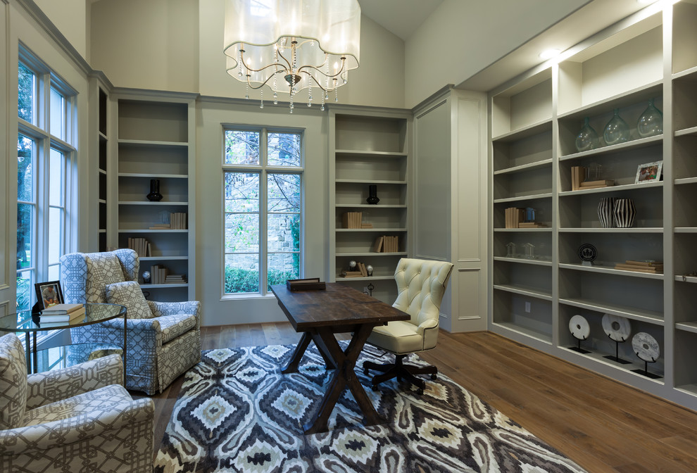 Inspiration for an expansive transitional study room in Houston with grey walls, light hardwood floors, a freestanding desk and brown floor.
