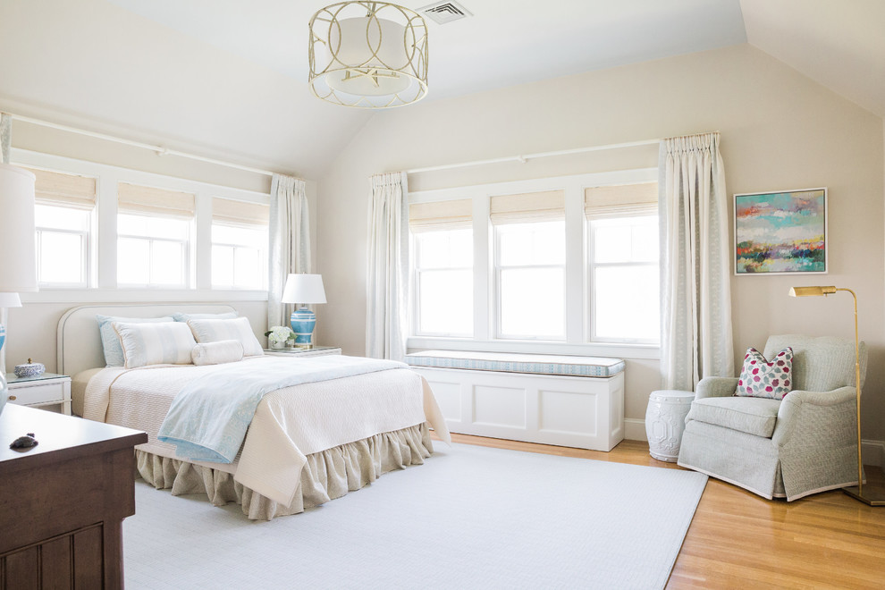 Inspiration for a beach style bedroom in Boston with beige walls and medium hardwood floors.