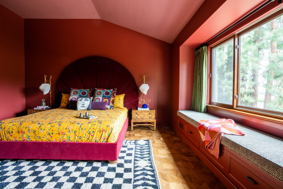 Stilmix Hauptschlafzimmer mit roter Wandfarbe, braunem Holzboden und gewölbter Decke in Orange County