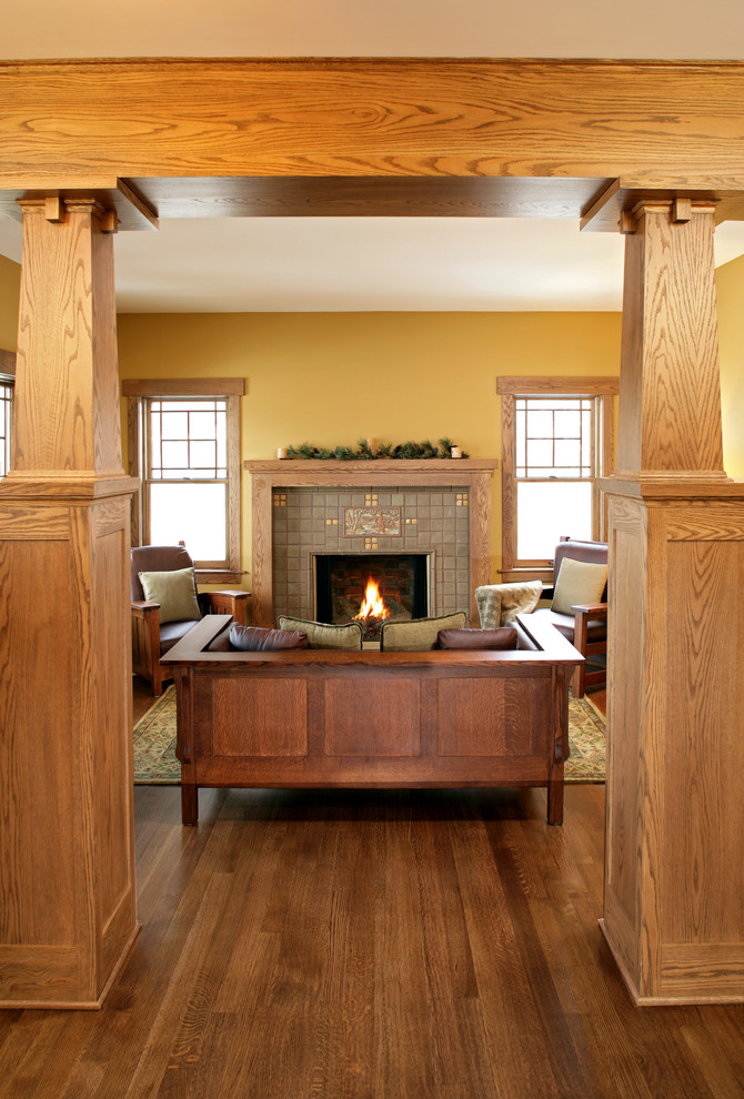 This is an example of an arts and crafts living room in Minneapolis with a tile fireplace surround and yellow walls.