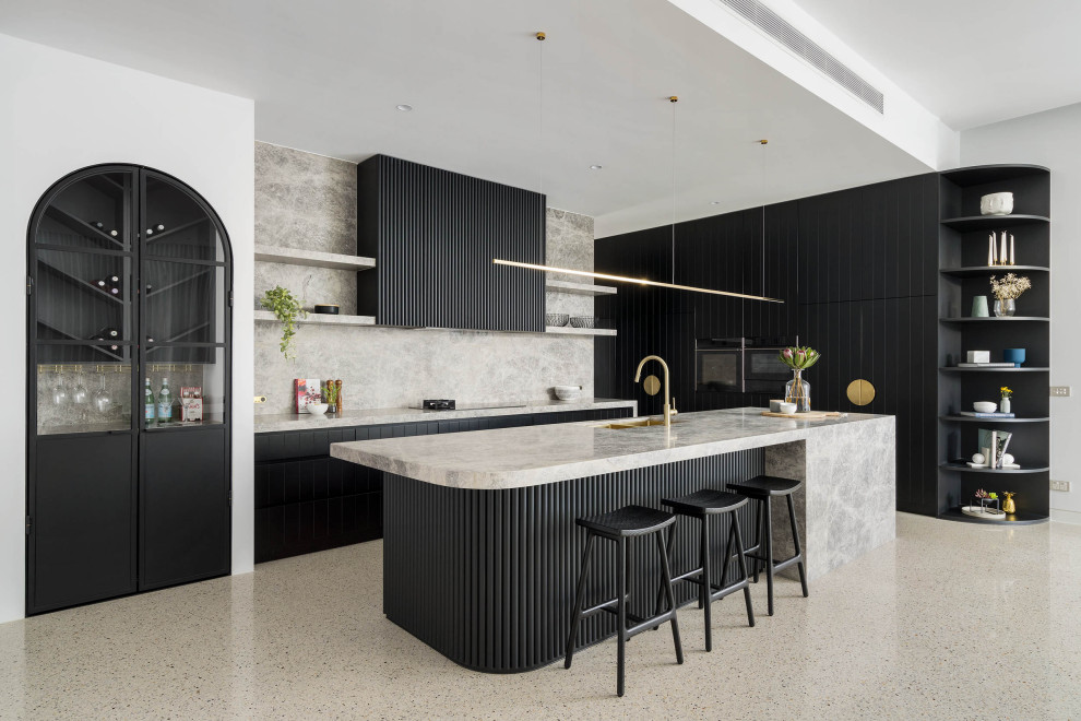 Large contemporary l-shaped open plan kitchen in Melbourne with a double-bowl sink, black cabinets, marble worktops, grey splashback, marble splashback, black appliances, concrete flooring, an island, grey floors and grey worktops.