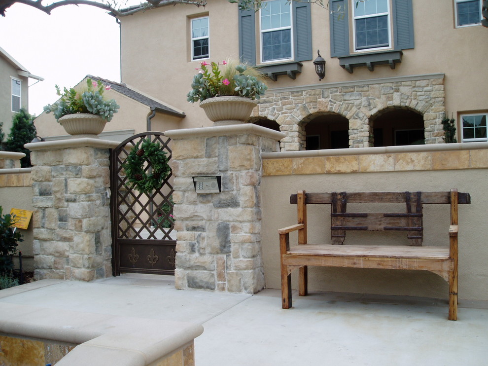 Inspiration for a mid-sized mediterranean front yard patio in San Diego with concrete slab and no cover.
