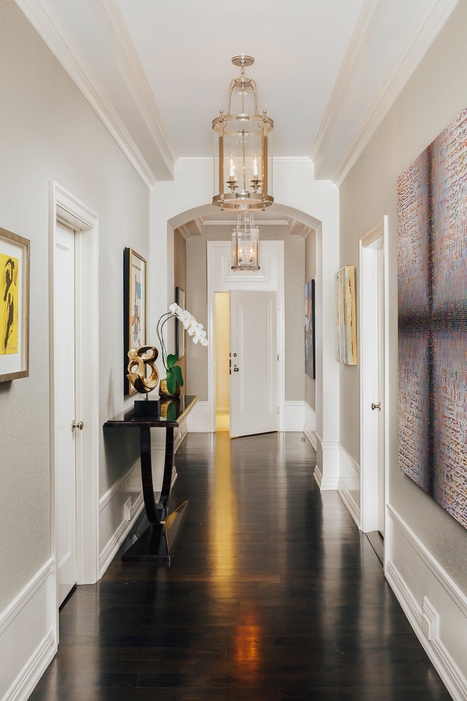 This is an example of a mid-sized traditional entry hall in San Francisco with beige walls, dark hardwood floors, brown floor, a single front door and a white front door.