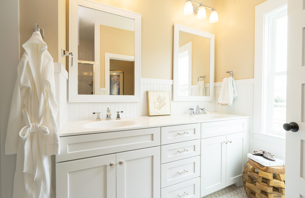 Inspiration for a beach style bathroom in Philadelphia with a wall-mount sink, shaker cabinets and white cabinets.