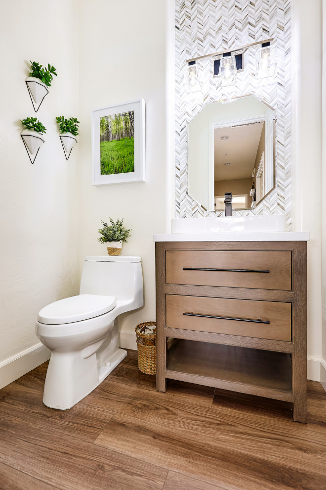 Photo of a medium sized classic cloakroom in Phoenix with medium wood cabinets, a one-piece toilet, multi-coloured tiles, mosaic tiles, white walls, porcelain flooring, engineered stone worktops, brown floors, white worktops, a freestanding vanity unit and a vessel sink.