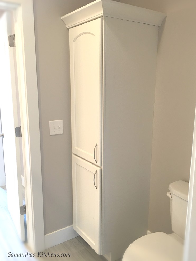 Home design - mid-sized transitional kids' porcelain tile home design idea with recessed-panel cabinets, white cabinets, a two-piece toilet and beige walls