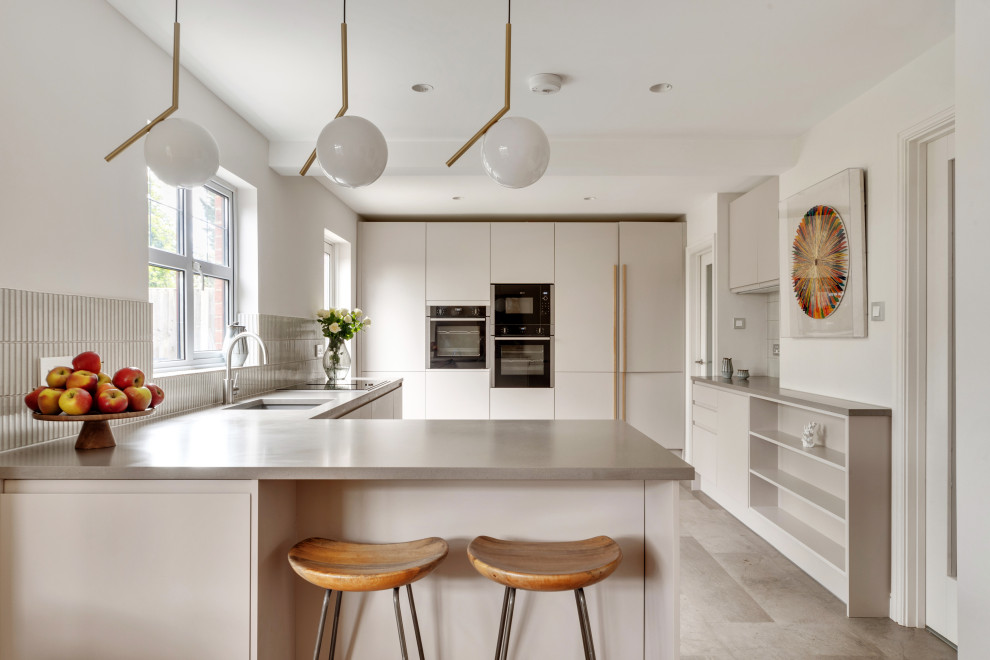 Design ideas for a contemporary u-shaped kitchen/diner in London with a submerged sink, flat-panel cabinets, grey cabinets, concrete worktops, grey splashback, integrated appliances, concrete flooring, a breakfast bar, grey floors and grey worktops.