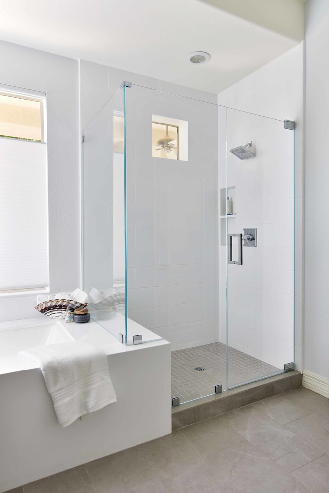 Mid-sized transitional master bathroom in Phoenix with recessed-panel cabinets, black cabinets, an undermount tub, a corner shower, white tile, ceramic tile, grey walls, ceramic floors, an undermount sink, engineered quartz benchtops, grey floor, a hinged shower door and white benchtops.