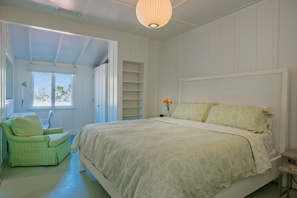 Photo of a large beach style master bedroom in Santa Barbara with white walls, painted wood floors and no fireplace.