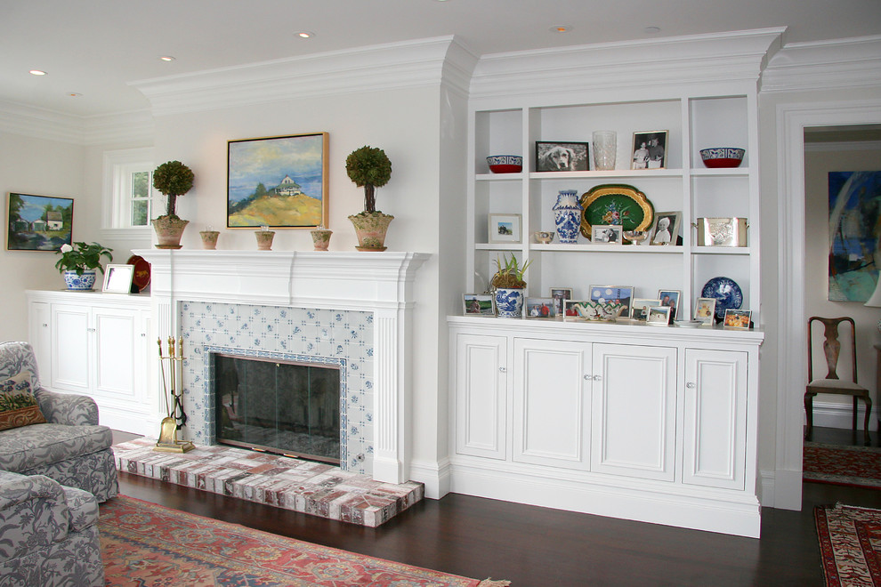 This is an example of a large traditional open concept family room in San Francisco with white walls, dark hardwood floors, a standard fireplace, a tile fireplace surround and no tv.