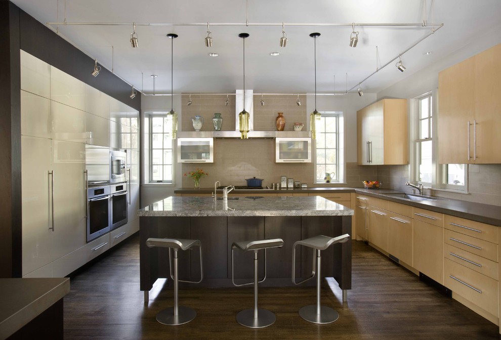 Inspiration for a contemporary u-shaped kitchen in Boston with flat-panel cabinets, stainless steel appliances, an undermount sink, light wood cabinets, quartz benchtops and beige splashback.
