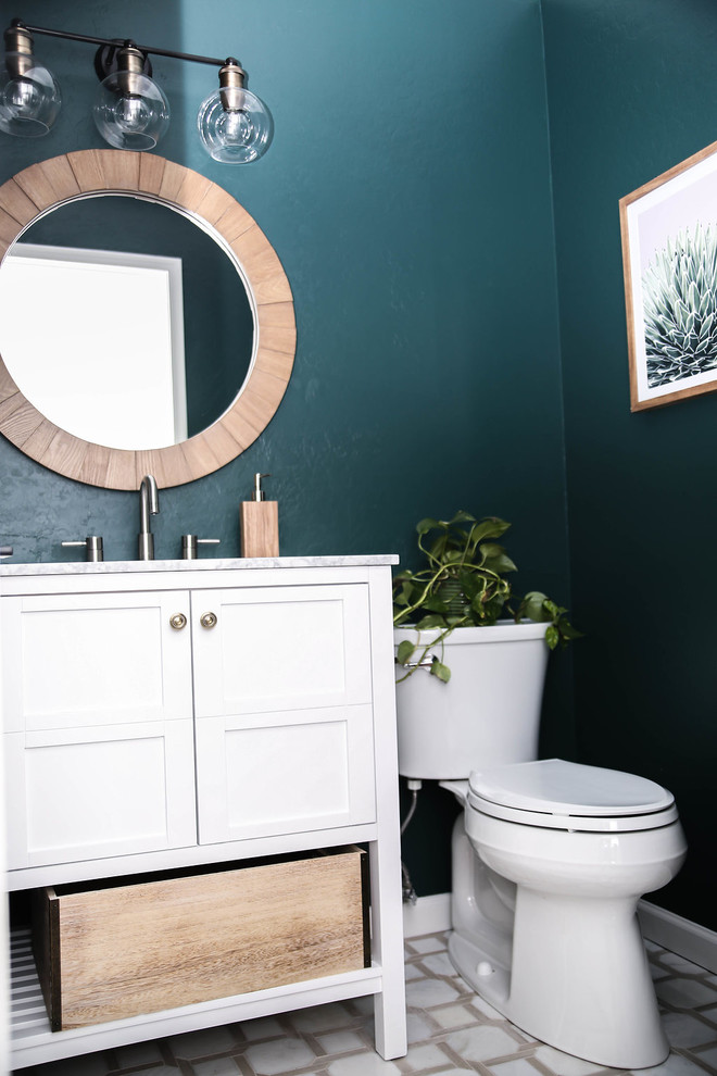 Photo of a small midcentury powder room in Phoenix with furniture-like cabinets, white cabinets, a one-piece toilet, green walls, ceramic floors, a console sink, marble benchtops, white floor and white benchtops.