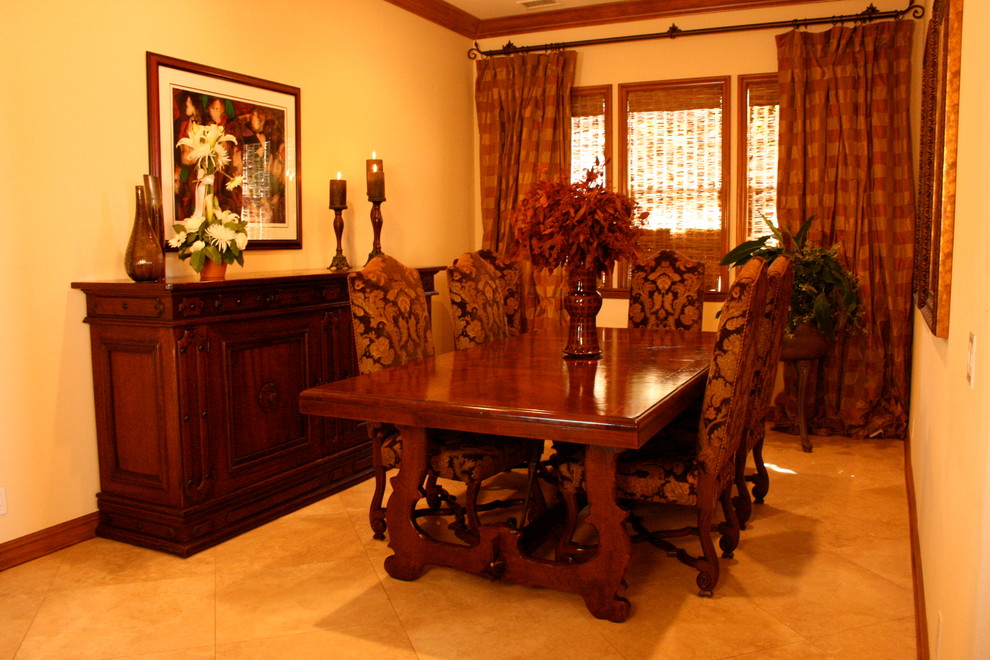 Small traditional separate dining room in Orange County with travertine floors.
