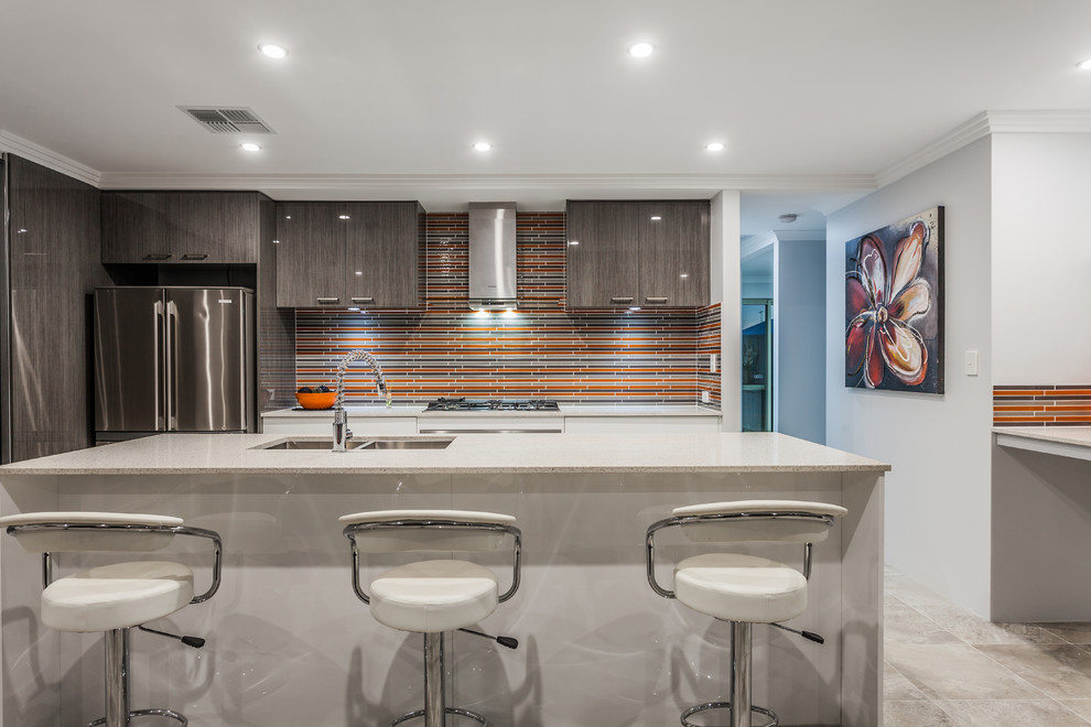 Design ideas for a large galley kitchen in Perth with an undermount sink, white cabinets, quartzite benchtops, orange splashback, ceramic splashback, stainless steel appliances, ceramic floors and with island.