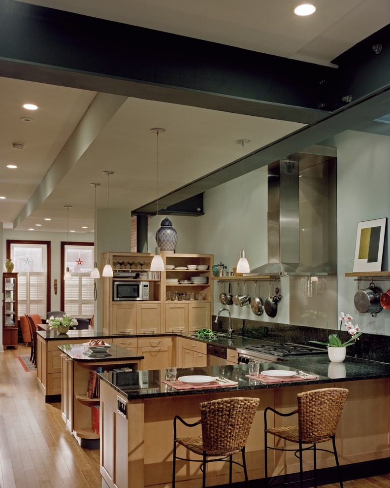 This is an example of a contemporary u-shaped eat-in kitchen in Philadelphia with shaker cabinets, light wood cabinets and stainless steel appliances.