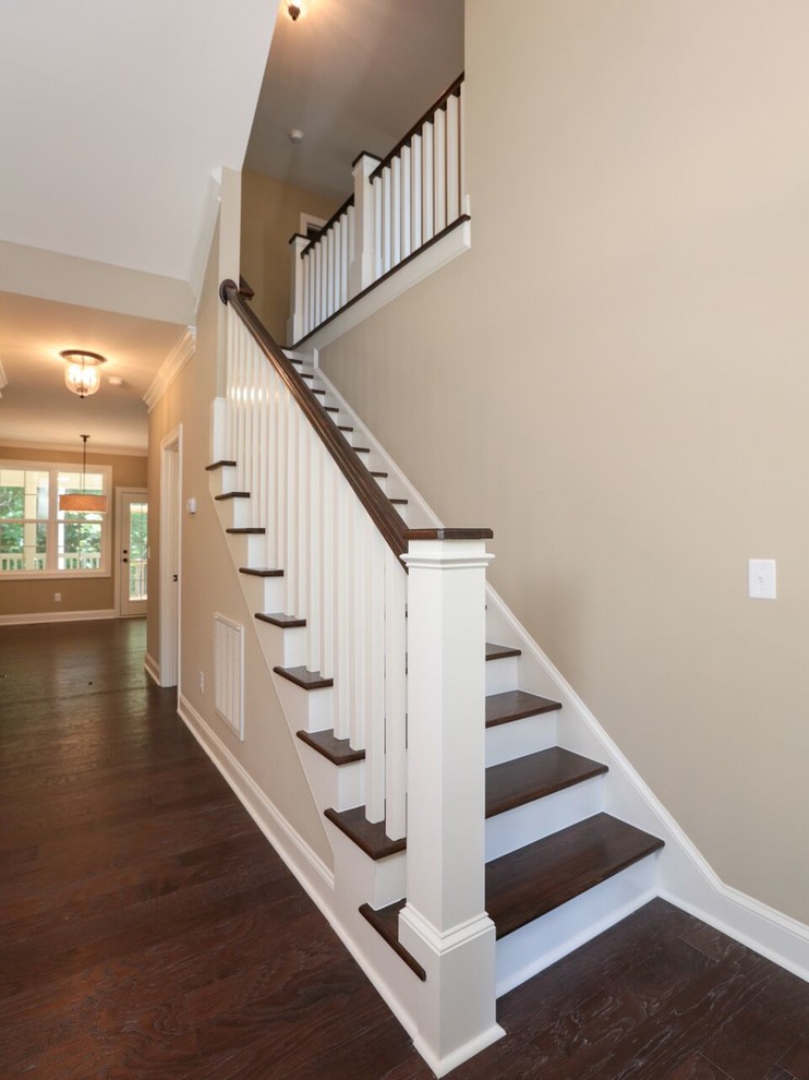 Inspiration for a mid-sized traditional wood straight staircase in Raleigh with painted wood risers.