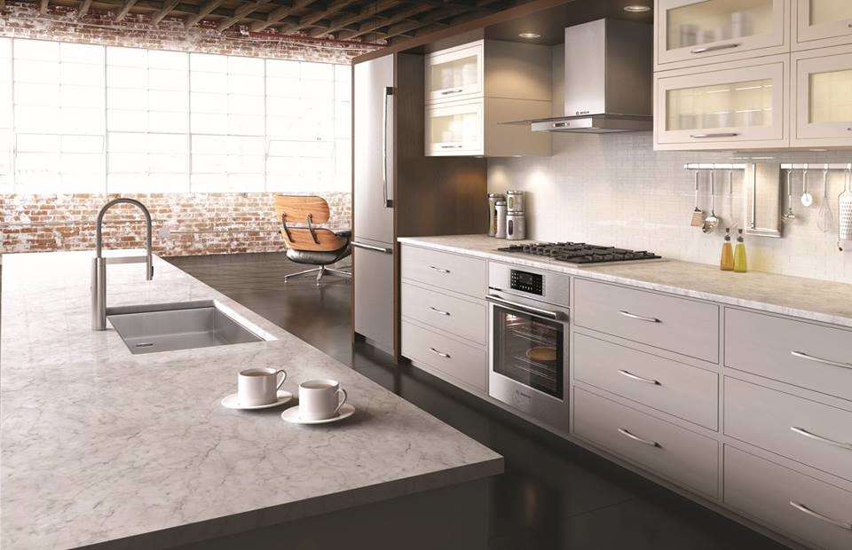 Large minimalist l-shaped dark wood floor eat-in kitchen photo in Houston with a drop-in sink, flat-panel cabinets, gray cabinets, marble countertops, white backsplash, stainless steel appliances and an island