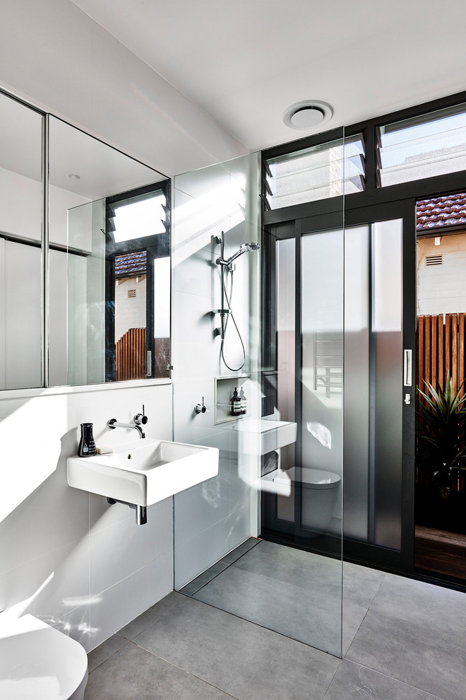 Design ideas for a large contemporary 3/4 bathroom in Sydney with a drop-in tub, an open shower, a one-piece toilet, white tile, ceramic tile, white walls, ceramic floors, an undermount sink, grey floor and an open shower.