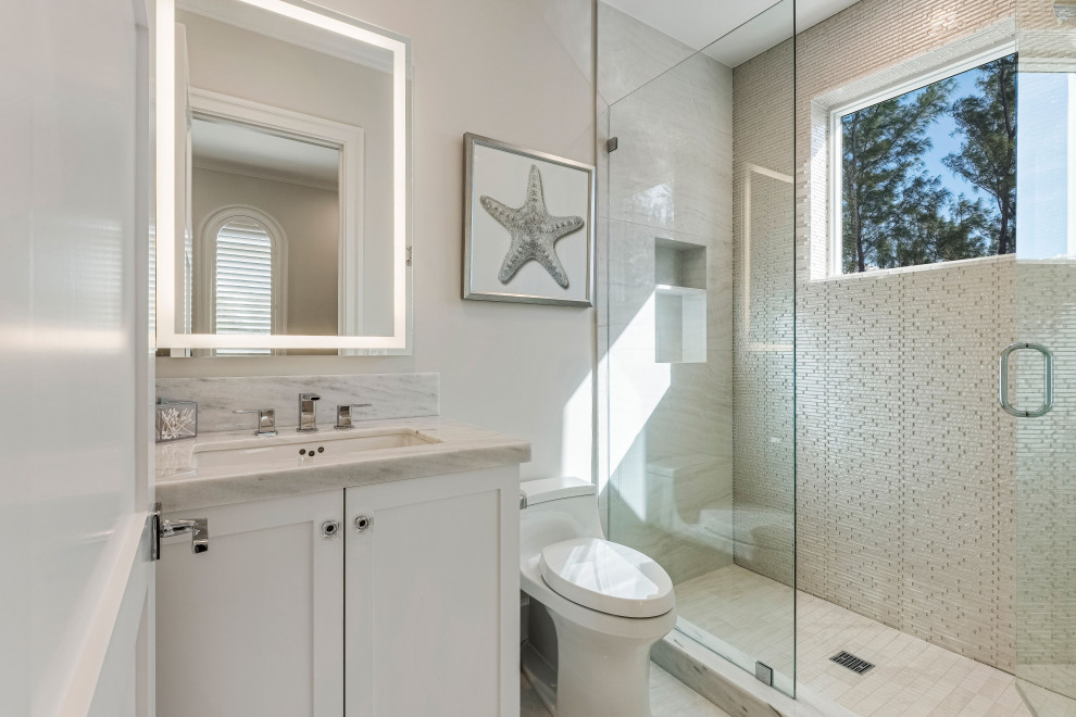 Large trendy kids' white tile and porcelain tile porcelain tile, white floor and single-sink doorless shower photo in Miami with recessed-panel cabinets, white cabinets, white walls, an undermount sink, marble countertops, a hinged shower door, white countertops, a niche and a built-in vanity
