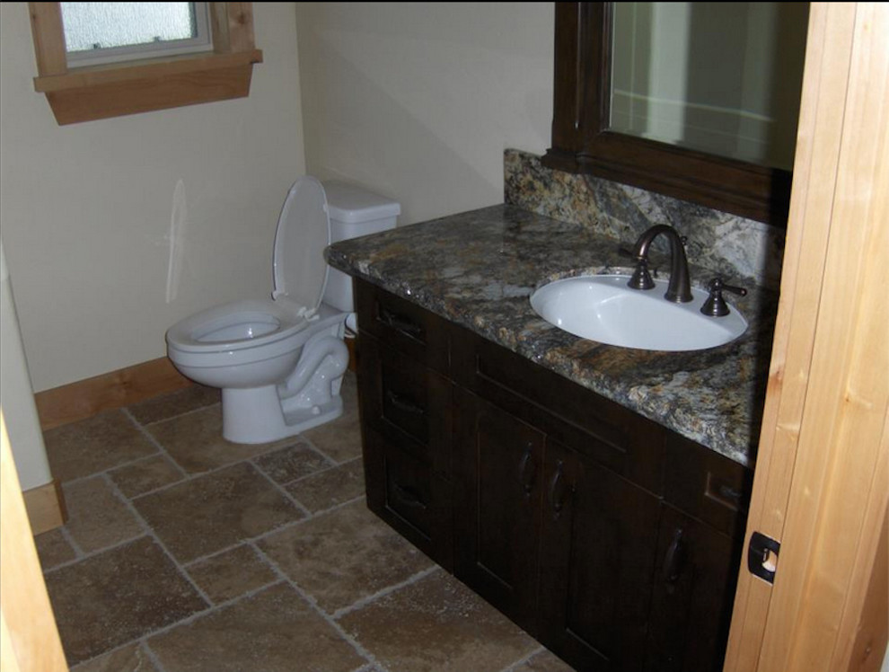 Inspiration for a 3/4 cement tile bathroom remodel with dark wood cabinets and a one-piece toilet