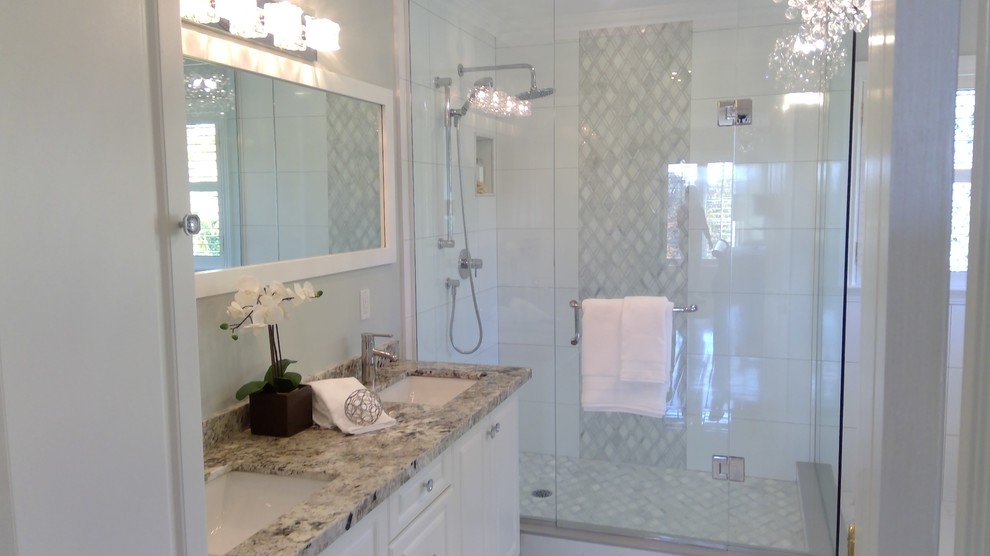 Mid-sized modern master bathroom in Toronto with shaker cabinets, turquoise cabinets, a freestanding tub, a corner shower, a one-piece toilet, beige walls, cement tiles, an undermount sink, quartzite benchtops, white floor, a hinged shower door and beige benchtops.