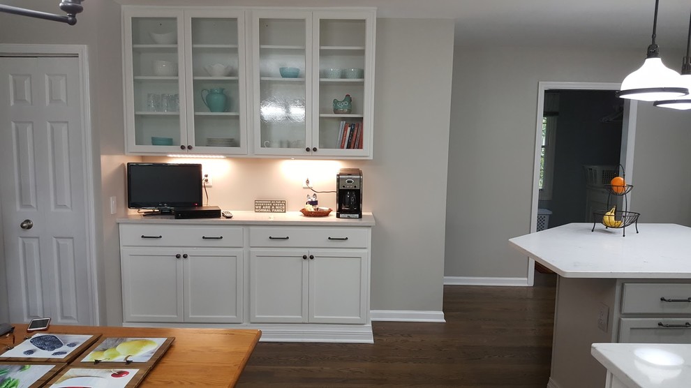 Large transitional u-shaped medium tone wood floor and brown floor eat-in kitchen photo in St Louis with an undermount sink, recessed-panel cabinets, white cabinets, quartzite countertops, white backsplash, ceramic backsplash, stainless steel appliances, an island and white countertops
