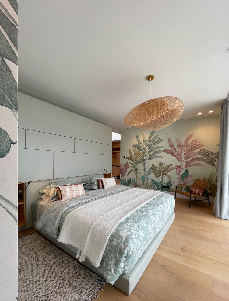 Inspiration for a medium sized world-inspired master bedroom in Other with green walls, medium hardwood flooring, brown floors and wallpapered walls.