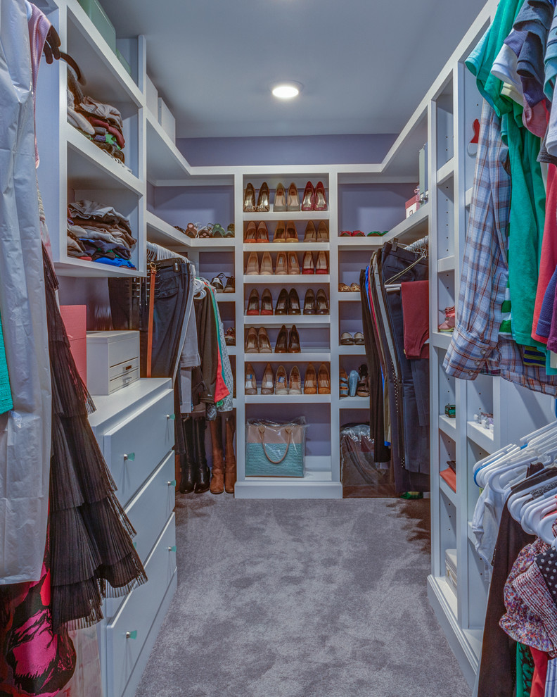 Photo of a mid-sized transitional walk-in wardrobe in Nashville with white cabinets and carpet.