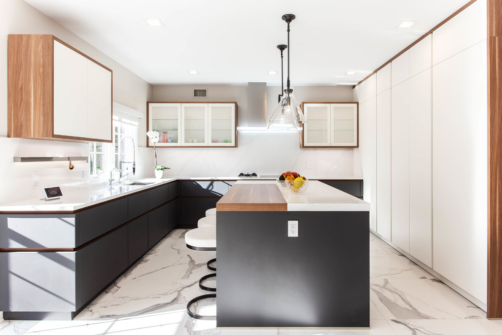 Photo of a large contemporary u-shaped eat-in kitchen in New York with an undermount sink, flat-panel cabinets, quartz benchtops, white splashback, stone slab splashback, panelled appliances, porcelain floors, with island, white floor, white benchtop and black cabinets.
