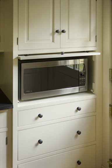 Photo of a traditional kitchen in Boston with beaded inset cabinets and white cabinets.
