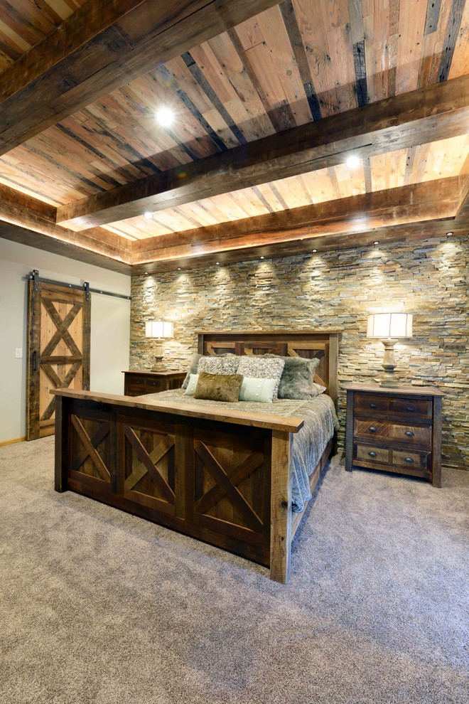 Large mountain style master carpeted bedroom photo with beige walls and no fireplace