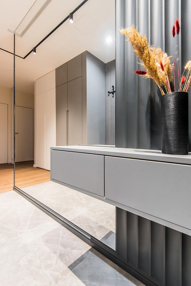 This is an example of a mid-sized contemporary entry hall in Moscow with black walls, porcelain floors, a single front door, a black front door, grey floor, recessed and panelled walls.
