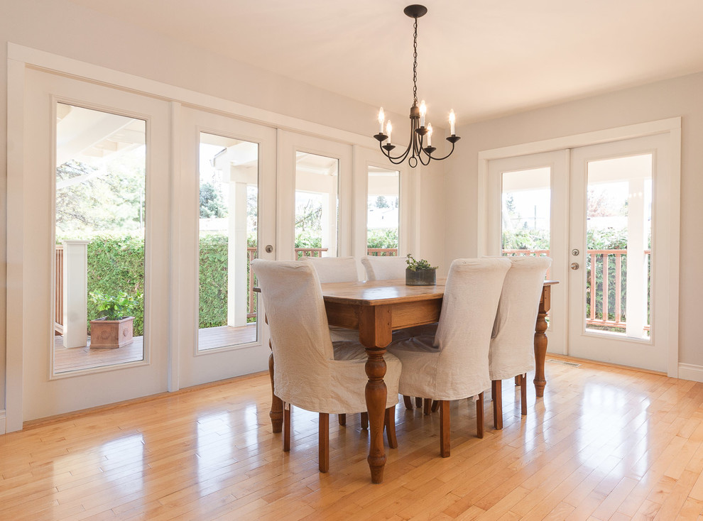 Inspiration for a traditional dining room in Vancouver with beige walls and medium hardwood floors.