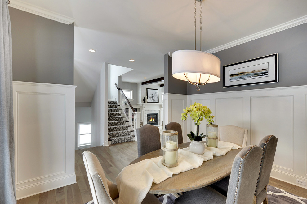 Inspiration for a traditional separate dining room in Minneapolis with grey walls and medium hardwood floors.