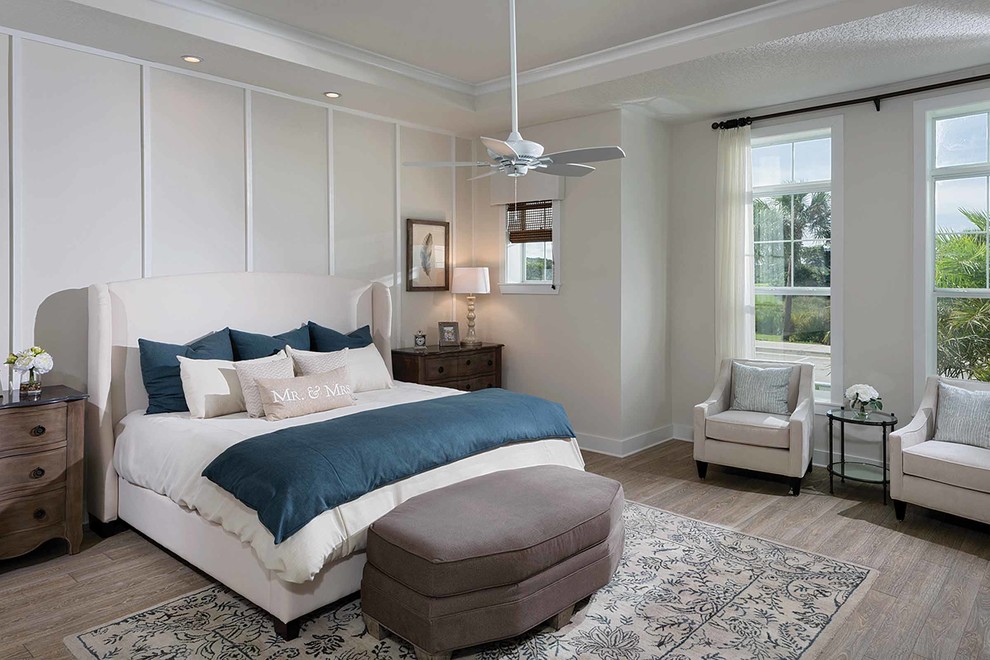 Inspiration for a mid-sized beach style master bedroom in Miami with beige walls, light hardwood floors, no fireplace and brown floor.