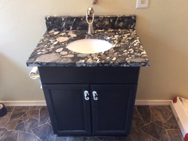 Small 3/4 linoleum floor and beige floor bathroom photo with recessed-panel cabinets, black cabinets, beige walls, an undermount sink and granite countertops