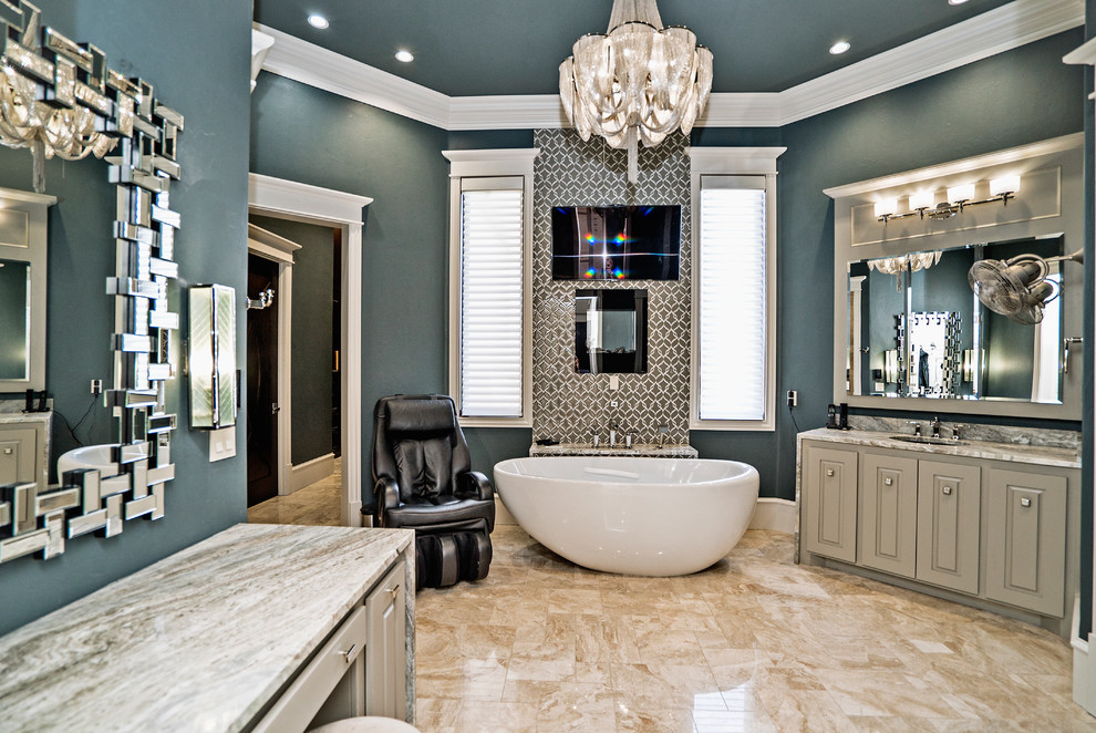 Inspiration for an expansive mediterranean master bathroom in Oklahoma City with raised-panel cabinets, beige cabinets, a freestanding tub, blue walls, porcelain floors, an undermount sink, granite benchtops, beige floor, beige benchtops, a double vanity and a built-in vanity.